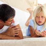 dad school age daughter talking on bed serious convo e1455069224767 | Stay at Home Mum.com.au