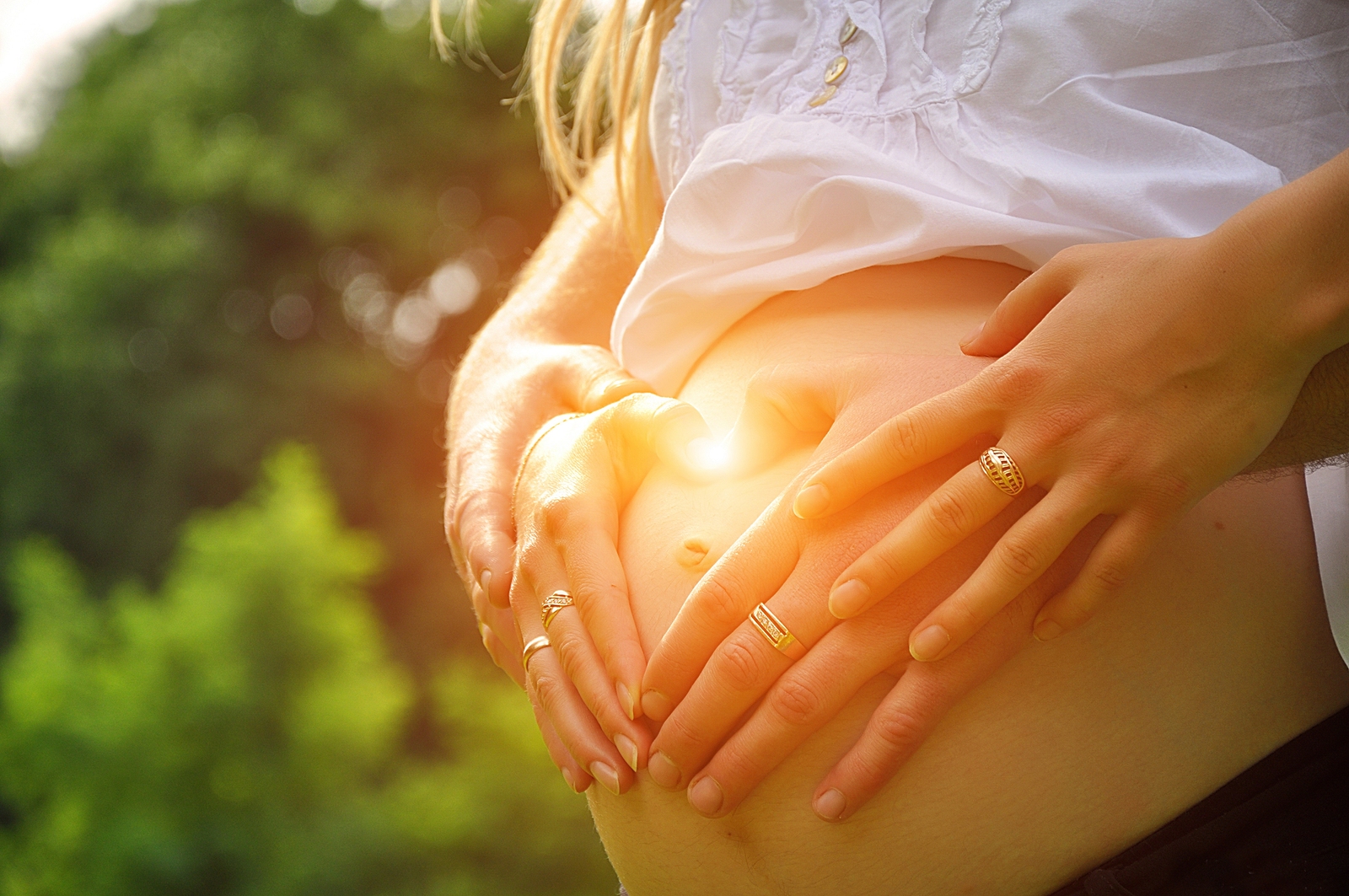 Pregnant Woman Holding Hand On Her Baby Bump