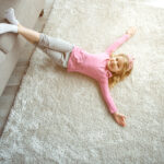 bigstock Happy Small Girl Lying On Floo 263080324 | Stay at Home Mum.com.au