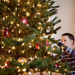 kid decorating christmas tree | Stay at Home Mum.com.au