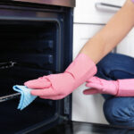 bigstock Woman Cleaning Oven Rack With 300971008 | Stay at Home Mum.com.au
