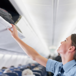 luggage in overhead bin of an airplane | Stay at Home Mum.com.au